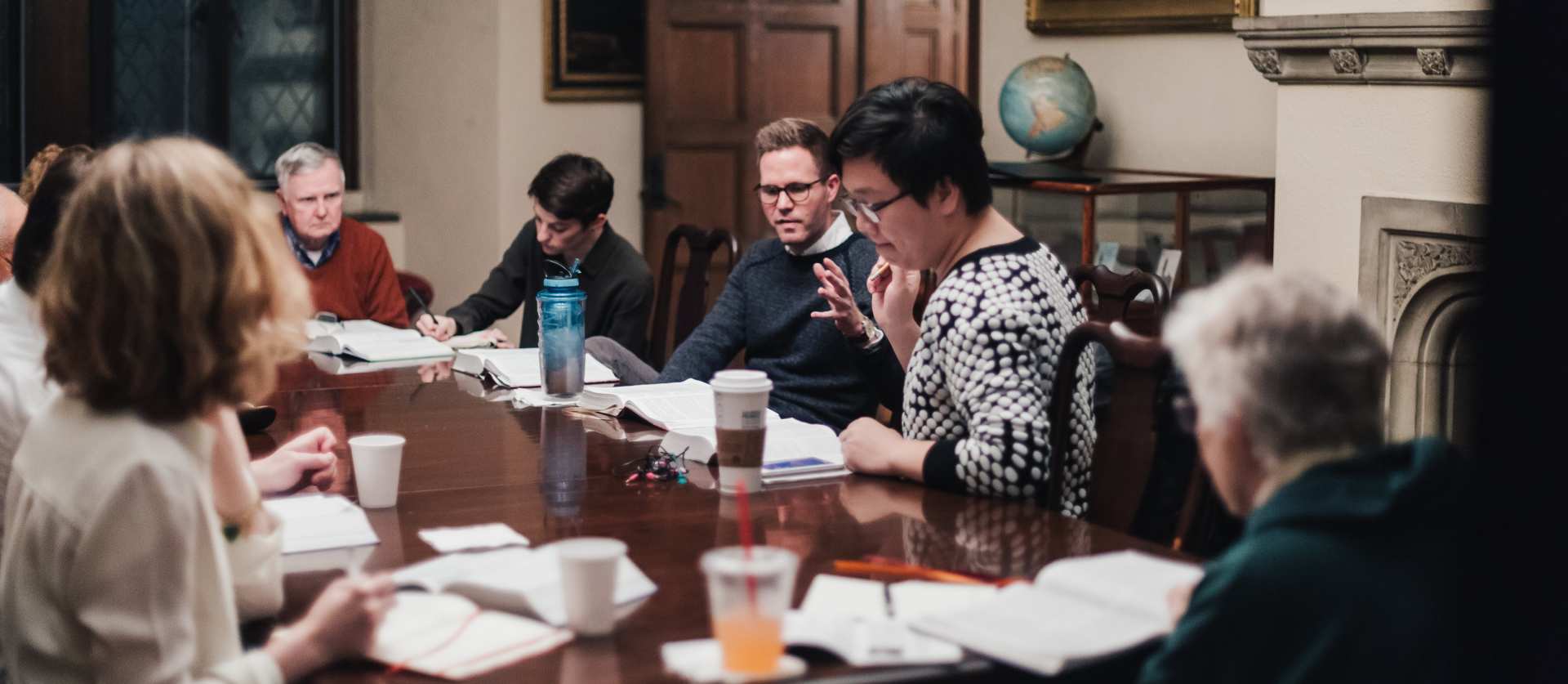 people sitting around a table for Bible study